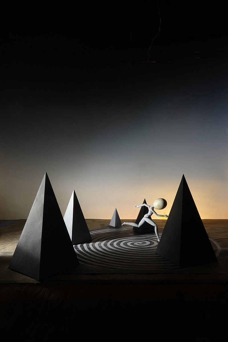 pyramids, surrealism, forboding imagery, anxiety imagery, fleeing figure, running away, surreal landscape photography