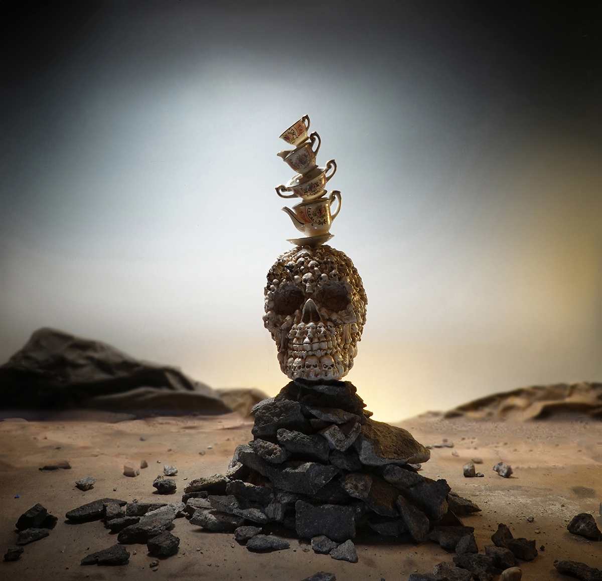 skull, surreal landscape, surrealism, symbolism, desert, surreal skull, upper class, the one percent, political commentary, fine chinaware, stacked chinaware, precious chinaware, surreal landscape photography