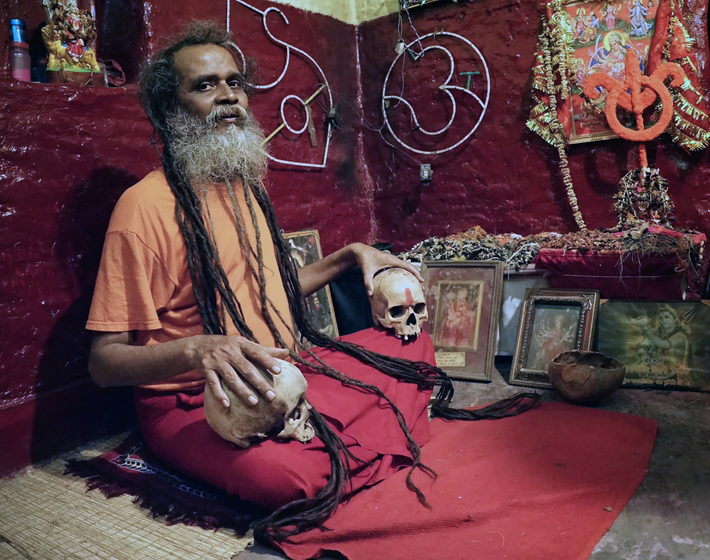 portrait, environmental, human skulls, sadhu, dreadlocks, ritual, religious paraphernalia, meditate, Varanasi, India