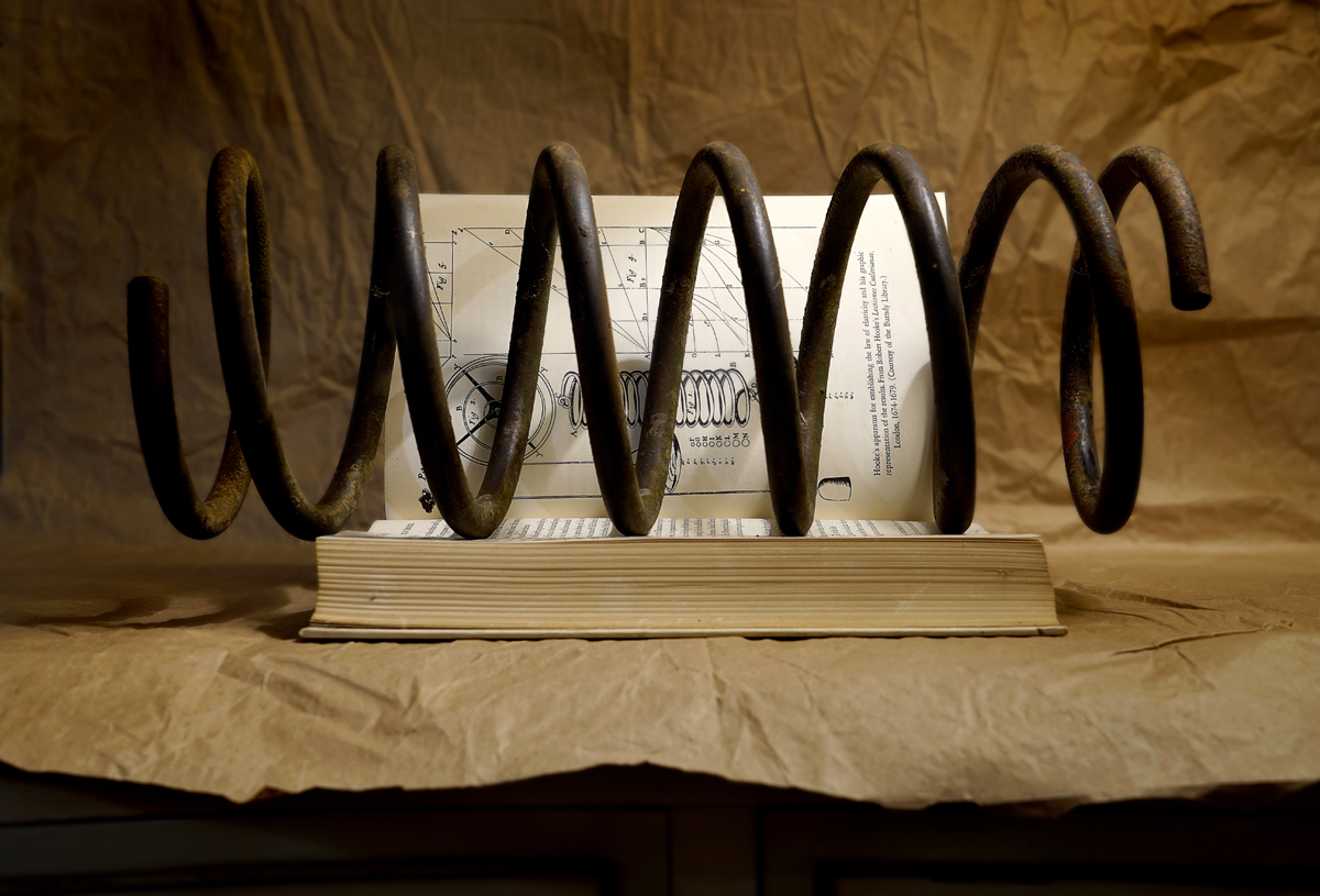 Still life, science, mechanics, laws of mechanics, book, steel spring